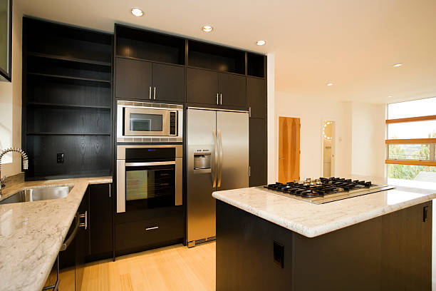 Photo of a modern kitchen with wood panel finishing and stainless steel appliances.